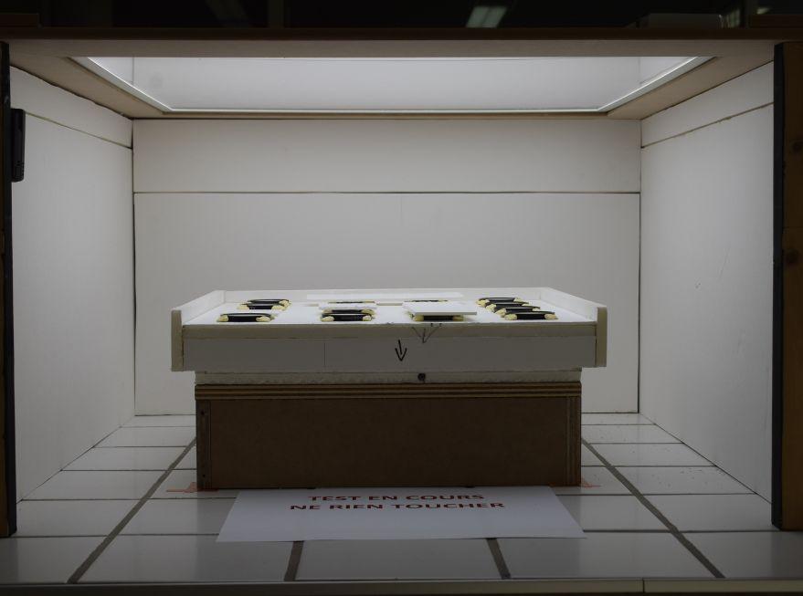 16 fragments d’enduits peints soumis à une lumière à travers des filtres optiques afin de définir un filtrage de la lumière d’exposition